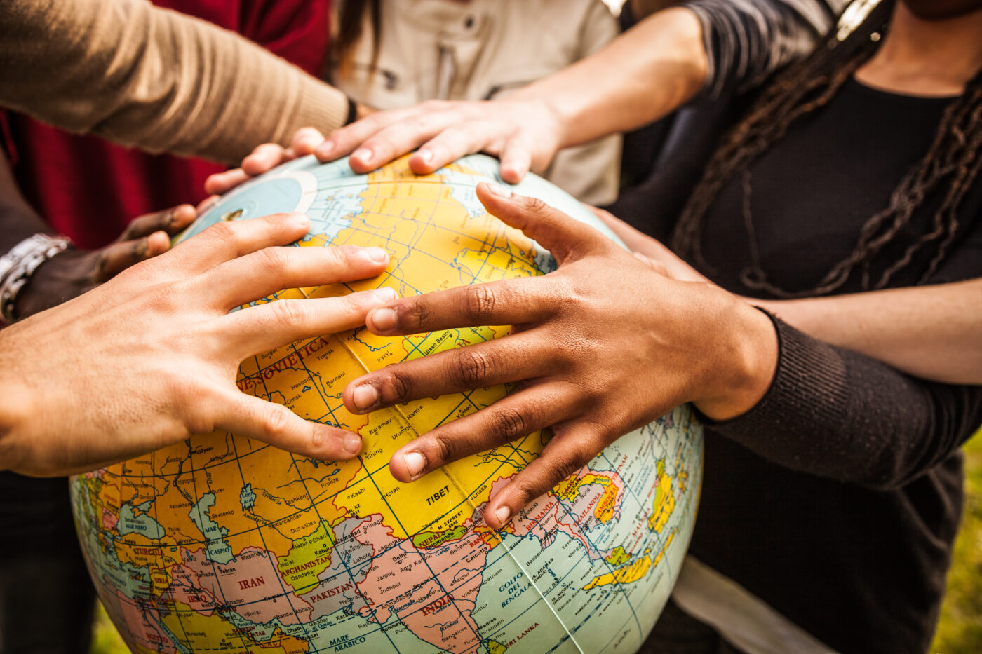Multi-ethnic group holding an earth globe